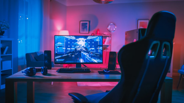 BEST GIFTS FOR TECHNOLOGY LOVERS: ACCESSORIES AND MORE, gaming desktop and chair in red and blue lighting